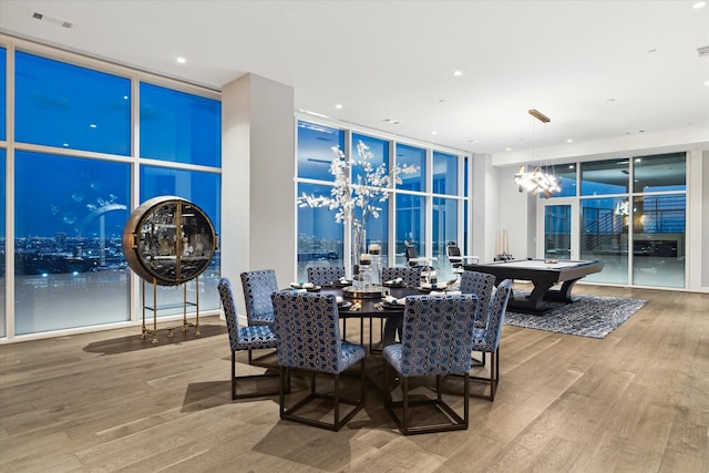 dining room featuring floor to ceiling windows, hardwood / wood-style flooring, and billiards