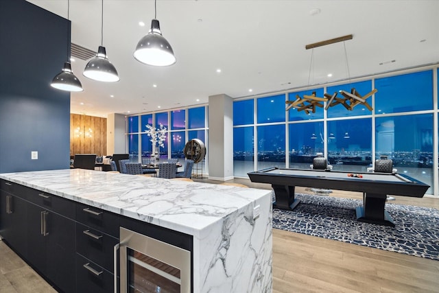 kitchen featuring a center island, wine cooler, billiards, light hardwood / wood-style floors, and pendant lighting