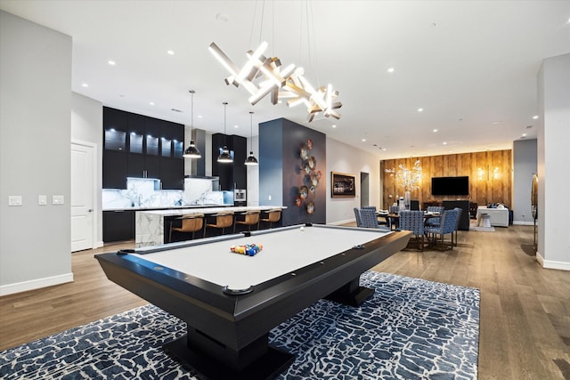 playroom featuring indoor bar, light hardwood / wood-style floors, and pool table