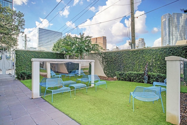 4521 San Felipe St Unit 3202, Houston, TX 77027 - exterior space featuring a fenced backyard, a patio, and a lawn