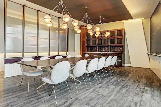 dining room with hardwood / wood-style floors and bar