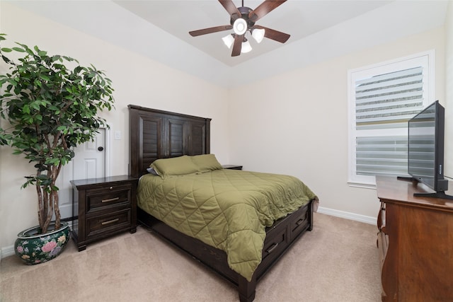 bedroom with vaulted ceiling, light colored carpet, and ceiling fan