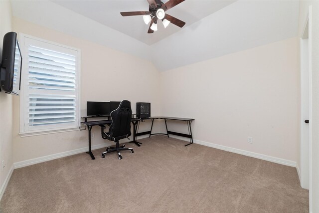 carpeted office space with ceiling fan and vaulted ceiling