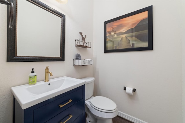 bathroom with toilet and vanity