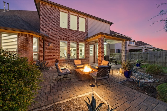 patio terrace at dusk featuring a fire pit