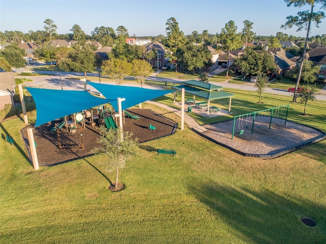 view of community featuring a playground and a lawn