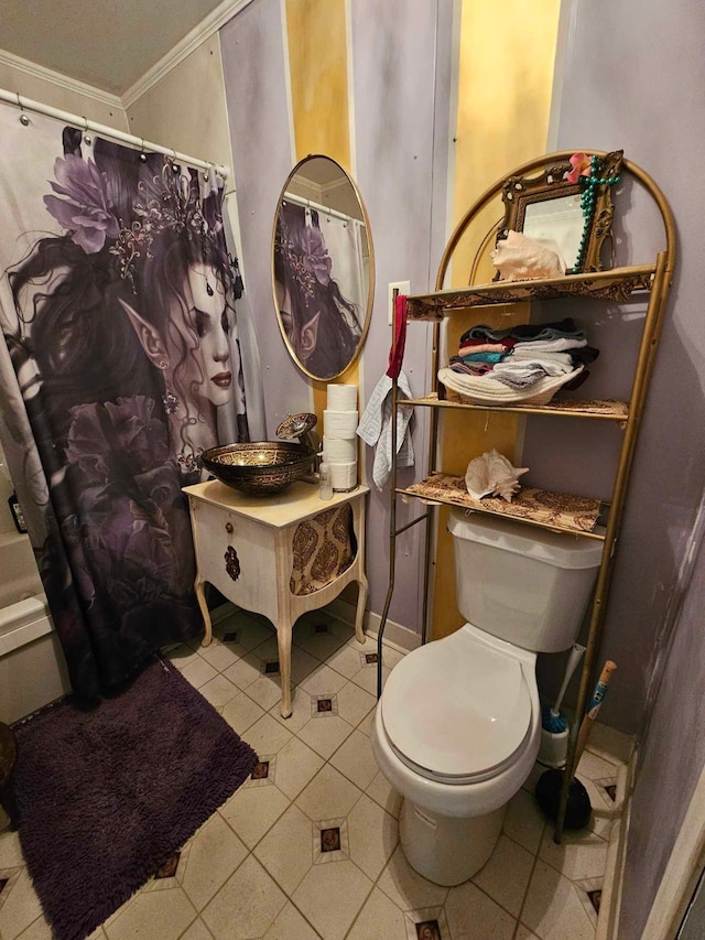 bathroom featuring toilet, tile patterned flooring, and ornamental molding