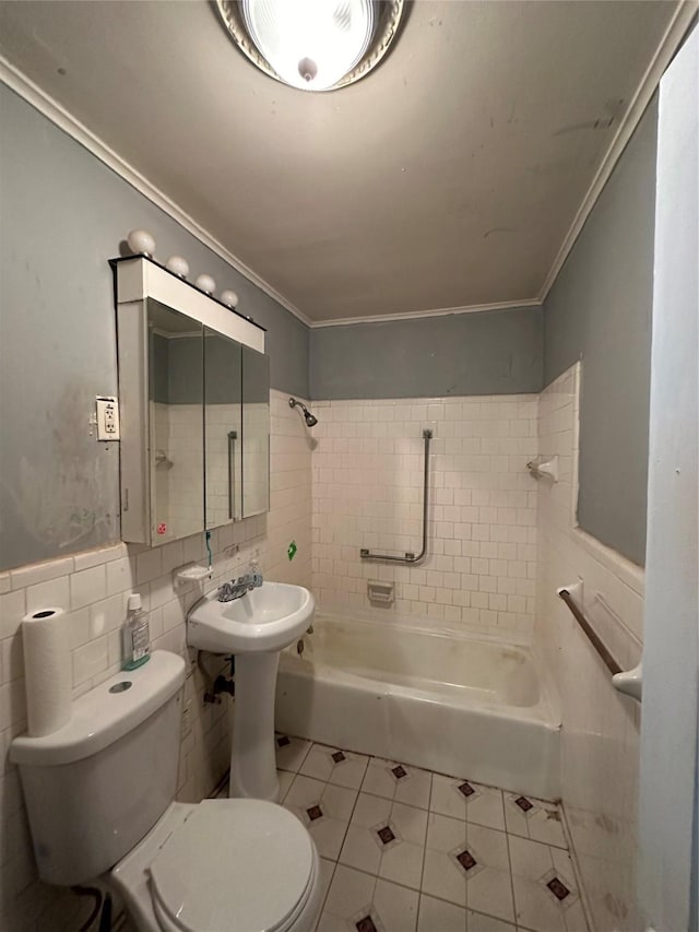 bathroom featuring toilet, tiled shower / bath combo, tile patterned floors, and ornamental molding