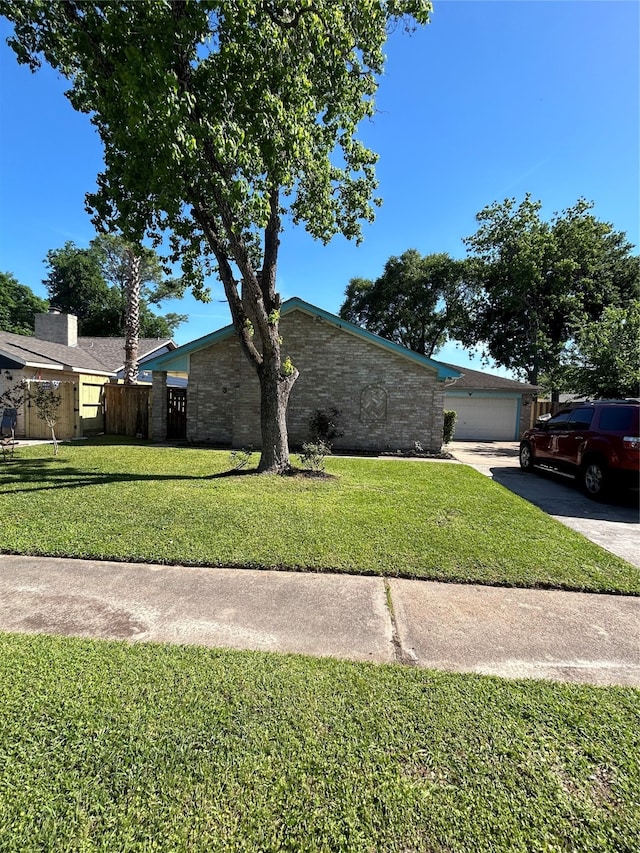 view of side of property featuring a garage and a yard