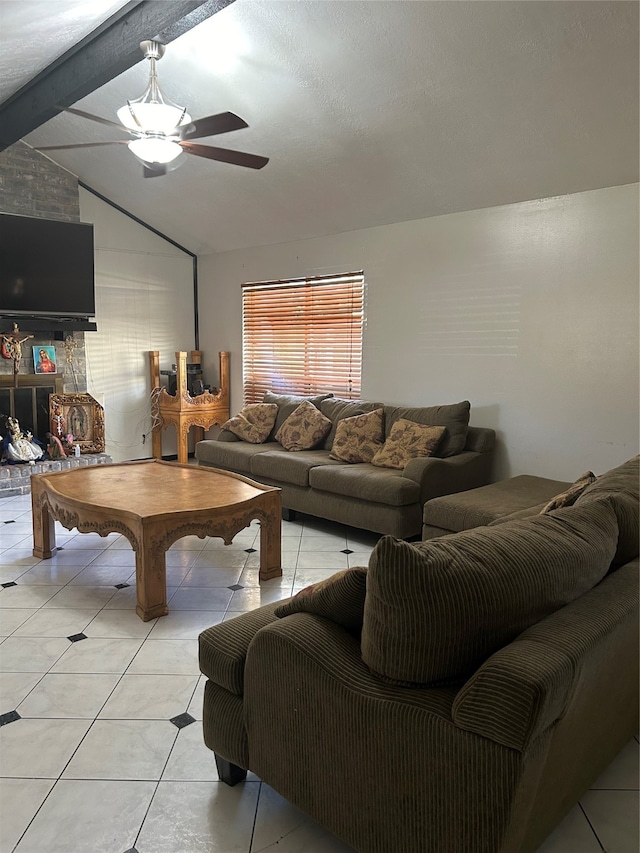 living room with vaulted ceiling with beams, ceiling fan, light tile patterned floors, and a textured ceiling