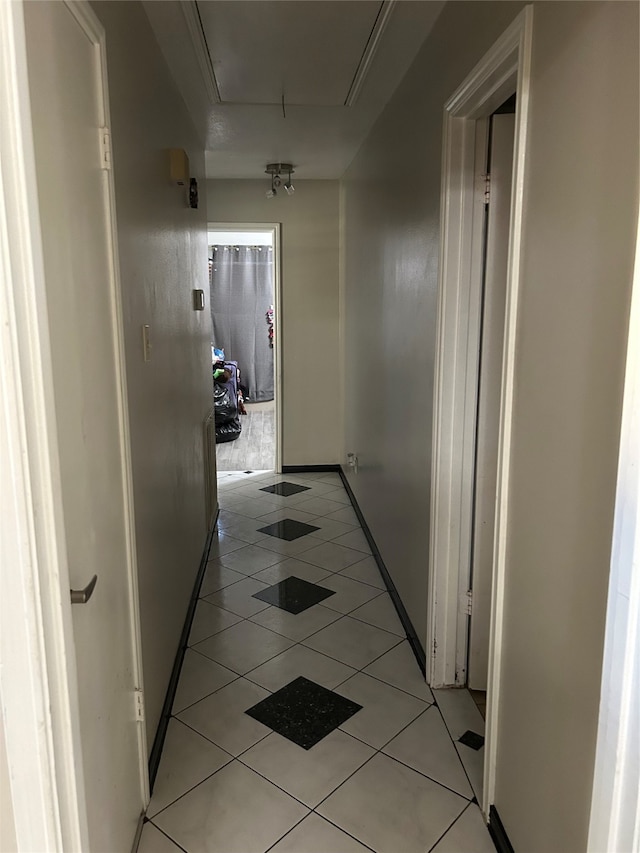 hall featuring light tile patterned floors