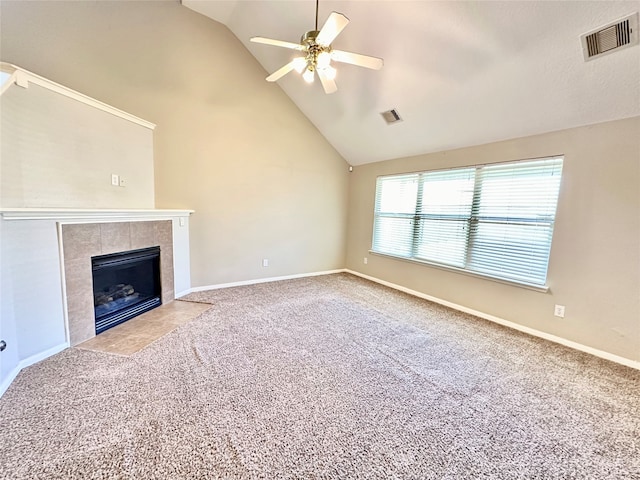 unfurnished living room featuring ceiling fan, carpet flooring, high vaulted ceiling, and a tile fireplace