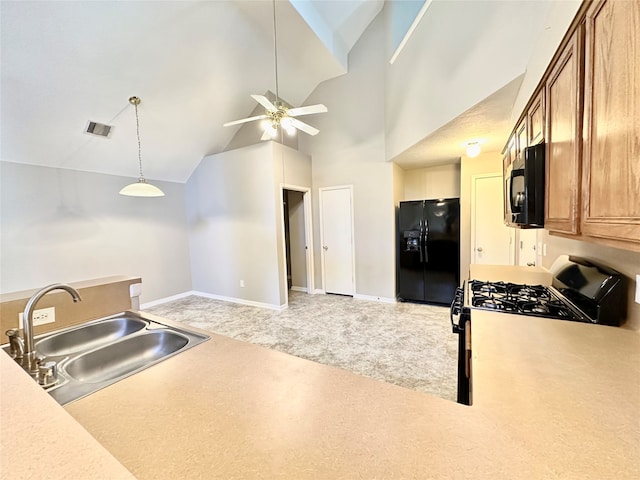 kitchen with range with gas cooktop, black fridge, carpet flooring, sink, and ceiling fan