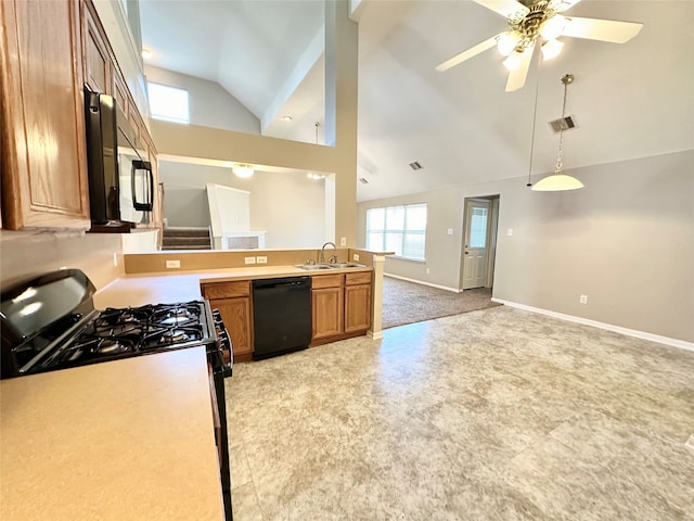 kitchen featuring dishwasher, sink, vaulted ceiling, gas range, and ceiling fan