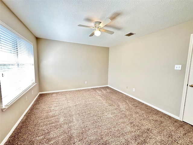 empty room featuring carpet floors, a textured ceiling, and ceiling fan