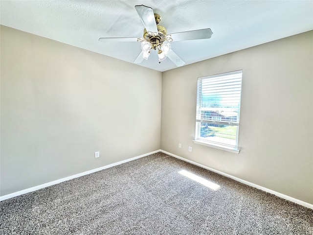 unfurnished room with ceiling fan, carpet flooring, and a textured ceiling