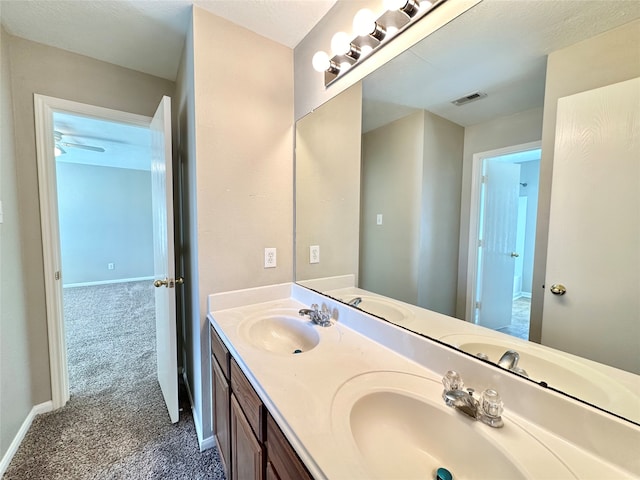 bathroom with ceiling fan and vanity