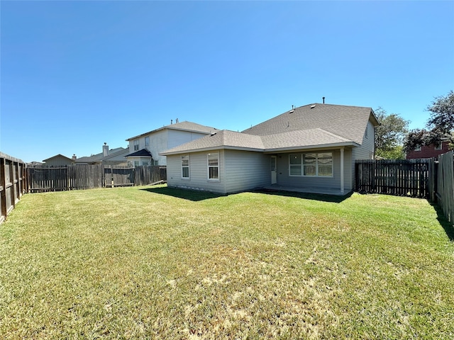 back of property featuring a lawn