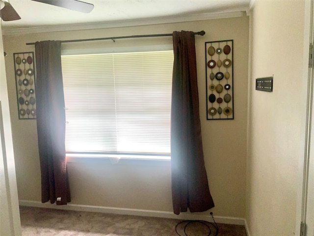 interior space featuring ornamental molding and light carpet