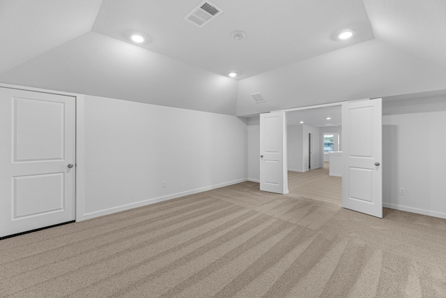 bonus room featuring light colored carpet and lofted ceiling