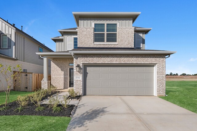 view of front of house with a front lawn and a garage