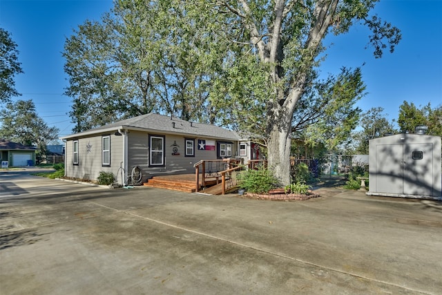 exterior space featuring an outdoor structure and a deck