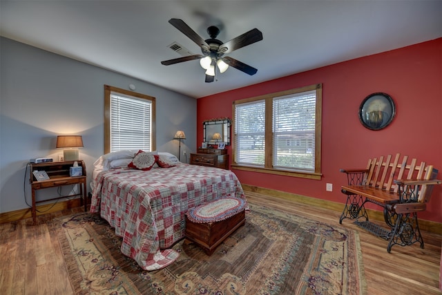 bedroom with ceiling fan and wood-type flooring