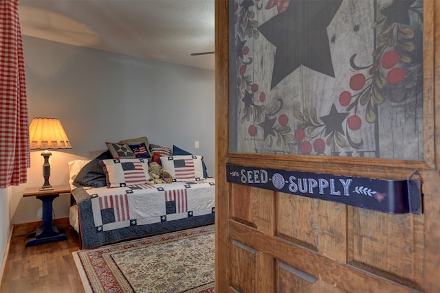 bedroom with wood-type flooring and ceiling fan