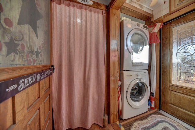 laundry area featuring ceiling fan and stacked washer / drying machine