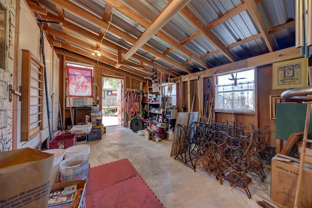 misc room with concrete floors, vaulted ceiling, and plenty of natural light