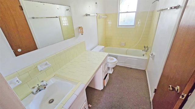 full bathroom featuring tiled shower / bath combo, vanity, and toilet