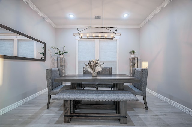 dining area featuring a chandelier, crown molding, and wood-type flooring