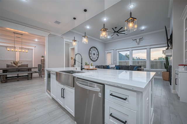 kitchen featuring ceiling fan, stainless steel dishwasher, sink, crown molding, and white cabinetry