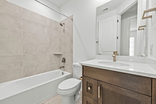 full bathroom with vanity, toilet, tile patterned flooring, and tiled shower / bath