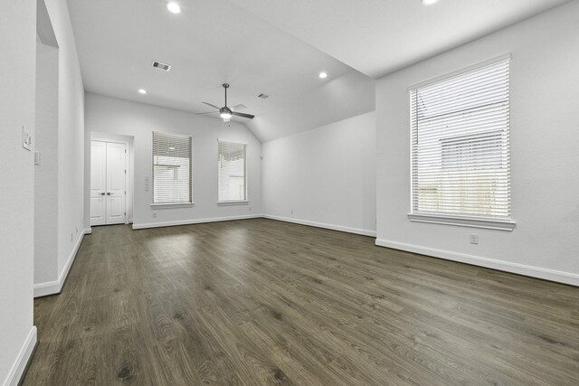 unfurnished living room featuring vaulted ceiling, hardwood / wood-style floors, plenty of natural light, and ceiling fan