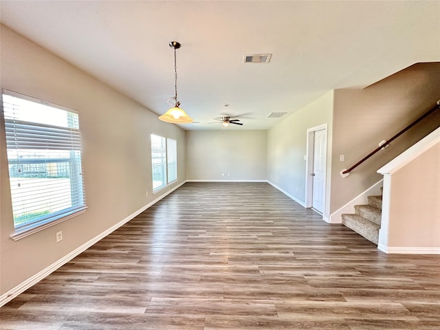 unfurnished room with wood-type flooring and ceiling fan