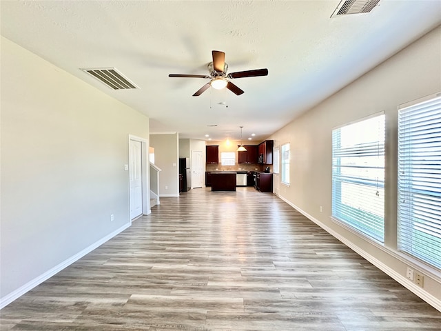 unfurnished living room with hardwood / wood-style floors and ceiling fan