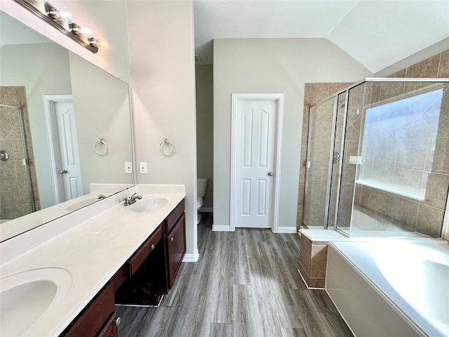 full bathroom featuring vaulted ceiling, vanity, independent shower and bath, hardwood / wood-style flooring, and toilet