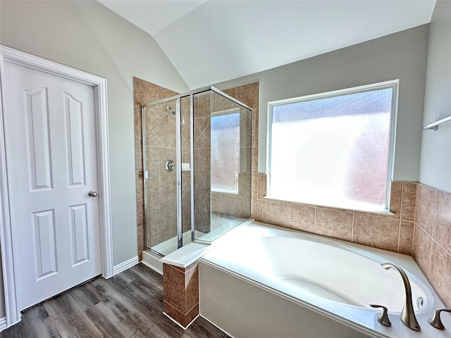 bathroom featuring lofted ceiling, separate shower and tub, and hardwood / wood-style flooring