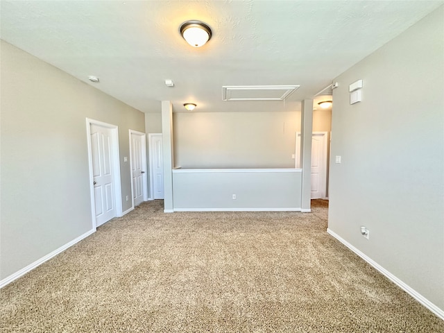 spare room with a textured ceiling and carpet floors