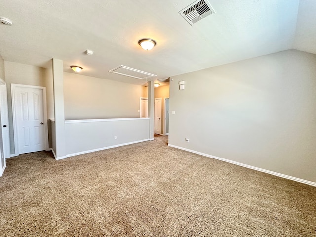 carpeted empty room featuring lofted ceiling