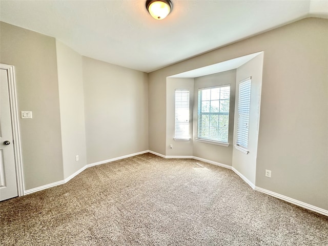 unfurnished room with carpet floors and lofted ceiling