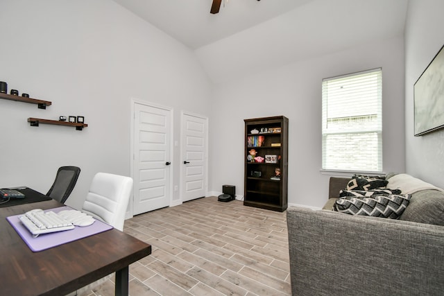 office with high vaulted ceiling, light hardwood / wood-style floors, and ceiling fan