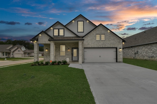 view of front facade with a garage and a lawn