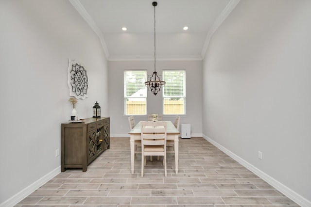 dining area featuring light hardwood / wood-style flooring, lofted ceiling, a notable chandelier, and ornamental molding