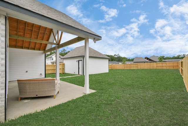 view of yard with a patio area and an outbuilding