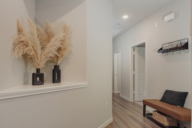 hallway with hardwood / wood-style floors