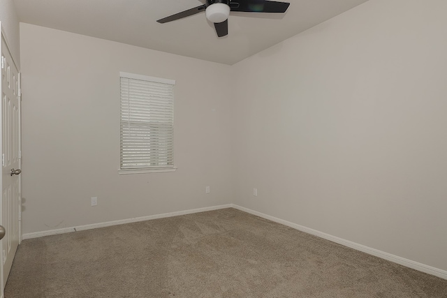 spare room featuring ceiling fan and light carpet