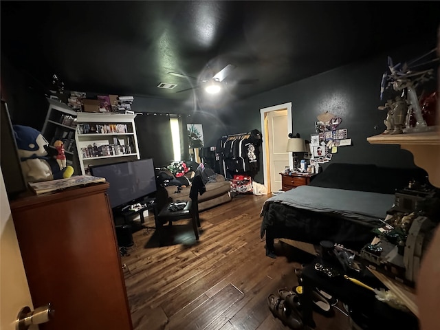 bedroom with ceiling fan and hardwood / wood-style flooring