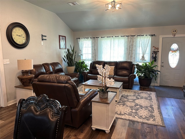 living room with vaulted ceiling, a chandelier, and dark wood-type flooring